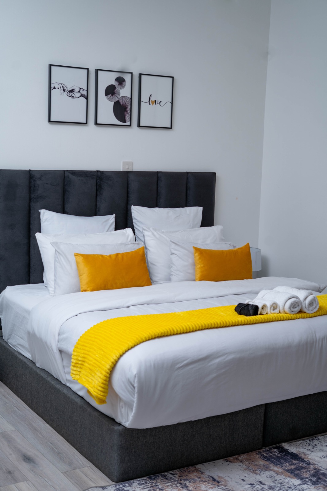 Ensuite bedroom with gallery wall art at Nichi Guesthouses