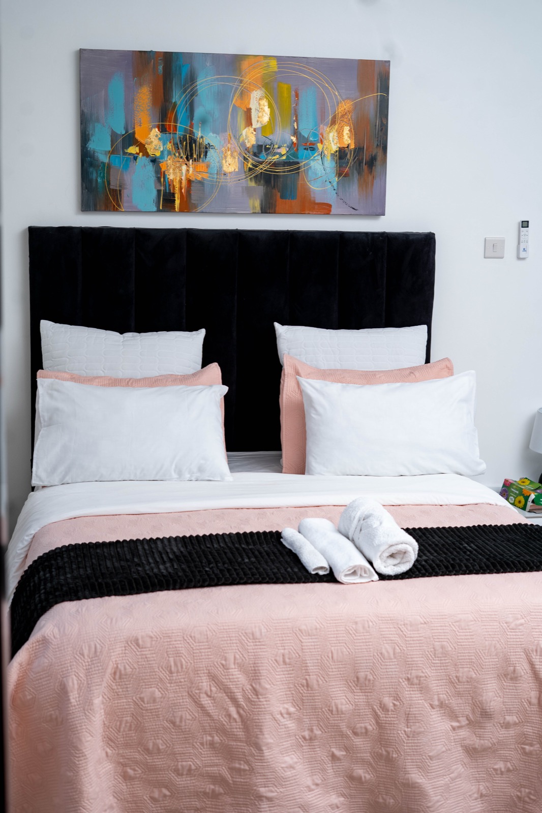 Ensuite bedroom with blush linens at Nichi Guesthouses