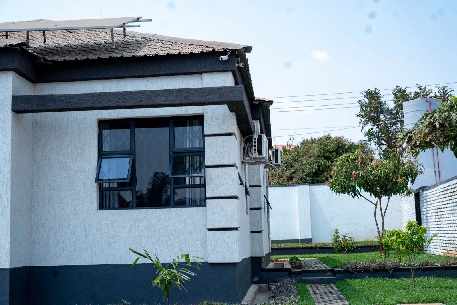 Side exterior view with solar panels and garden at Nichi Guesthouses