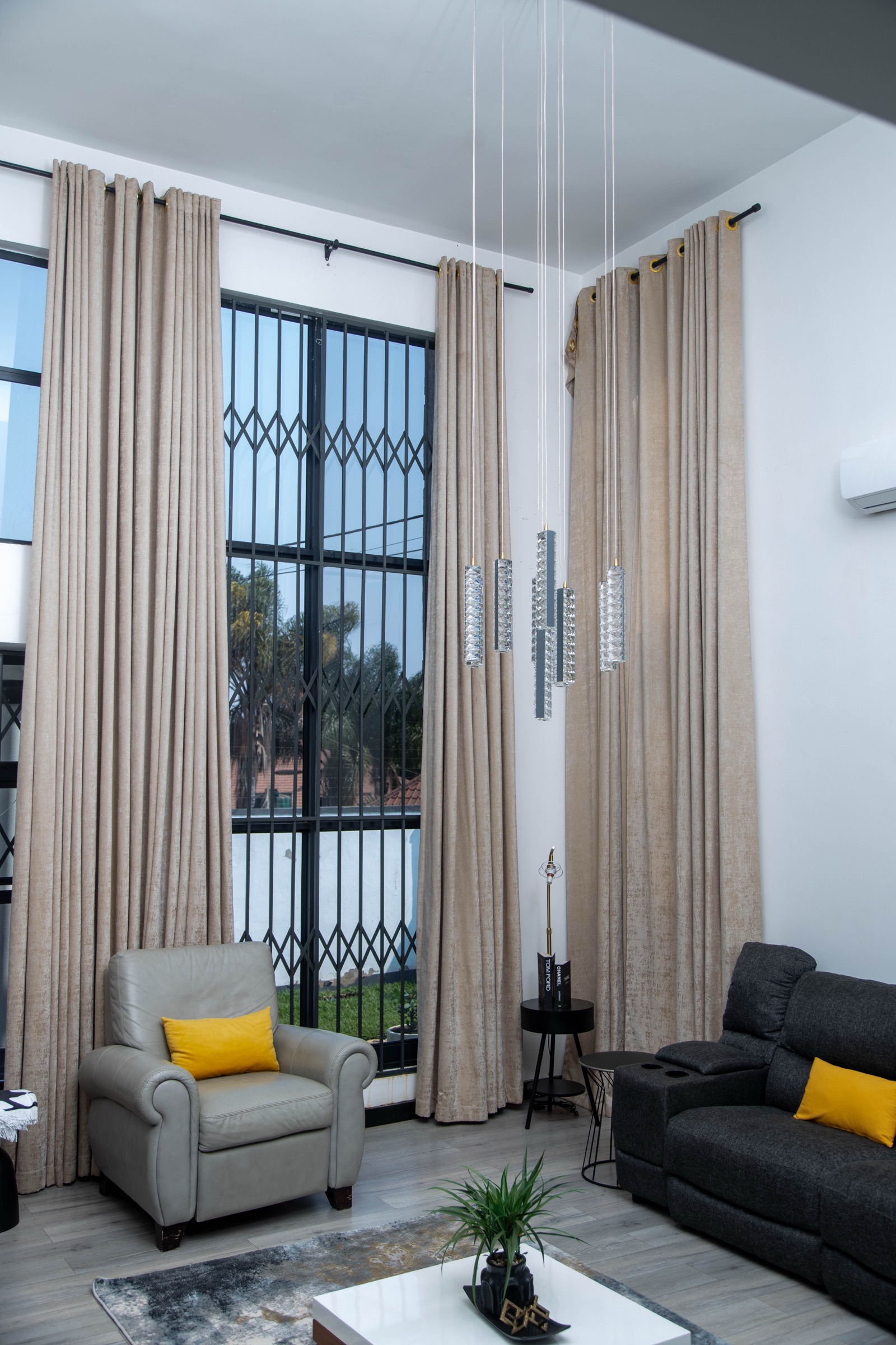 Living room at Nichi Guesthouses with tall curtains and a leather armchair
